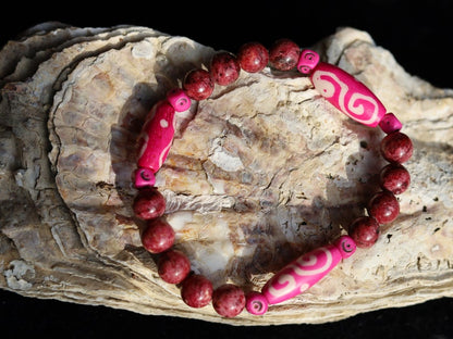 Rhodonite Beads bracelet with Fuschia Tumbling Dice. Bone gemstone jewelry. Haḍīāṁ Jewel winter Collection