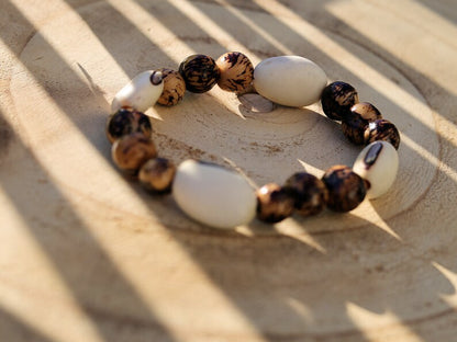 Unique Huayruro white bracelet with Acai rajado beads. Beautiful seeds, but also because they are a good luck symbol.