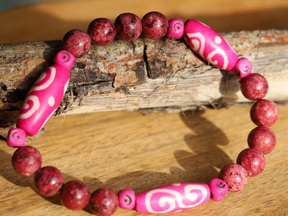 Rhodonite Beads bracelet with Fuschia Tumbling Dice. Bone gemstone jewelry. Haḍīāṁ Jewel winter Collection