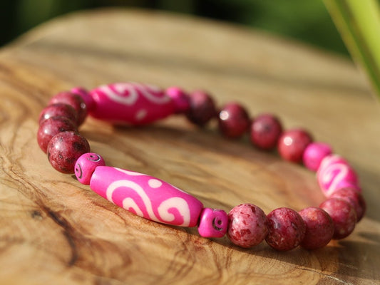 Rhodonite Beads bracelet with Fuschia Tumbling Dice. Bone gemstone jewelry. Haḍīāṁ Jewel winter Collection
