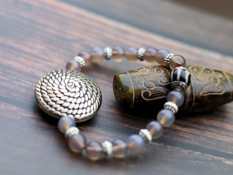 Quality AAA Gray Agates Natural Stone bracelet with a Unique Silver color metal look coin and Tibetan Style dZi Bead.