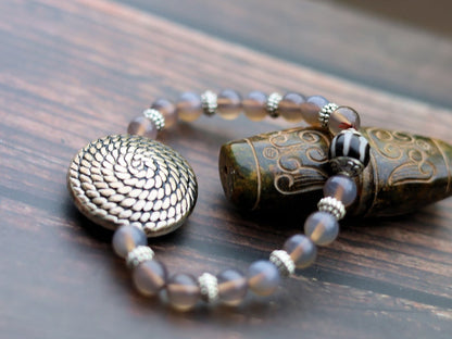 Quality AAA Gray Agates Natural Stone bracelet with a Unique Silver color metal look coin and Tibetan Style dZi Bead.