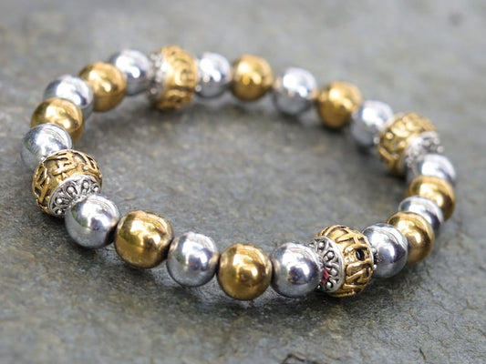 Gorgeous shiny Silver/ Gold Hematite 8 mm bracelet with Two—tone Metal Spacer Bead.