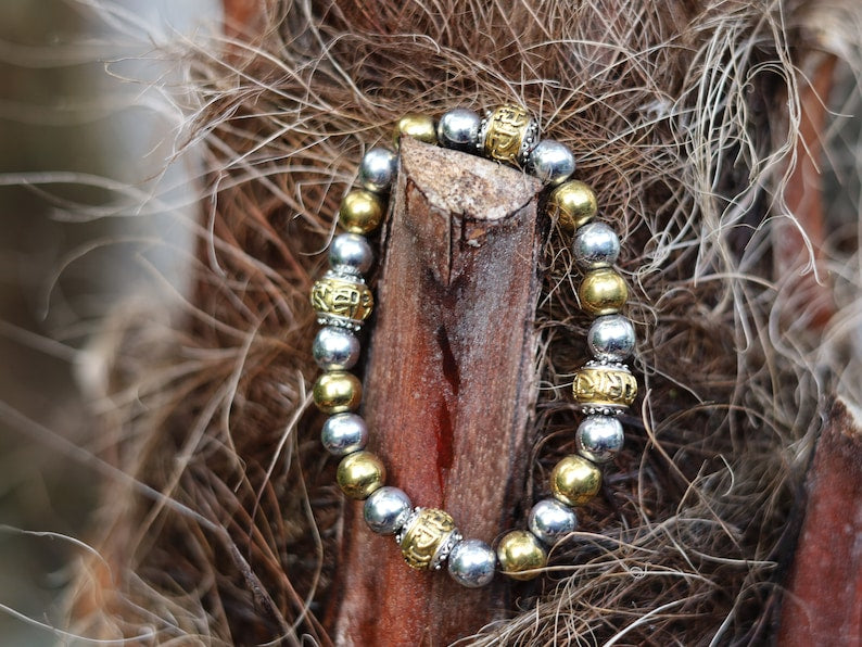 Gorgeous shiny Silver/ Gold Hematite 8 mm bracelet with Two—tone Metal Spacer Bead.