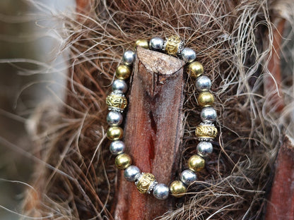 Gorgeous shiny Silver/ Gold Hematite 8 mm bracelet with Two—tone Metal Spacer Bead.