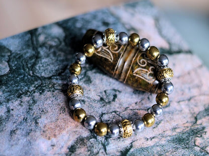 Gorgeous shiny Silver/ Gold Hematite 8 mm bracelet with Two—tone Metal Spacer Bead.