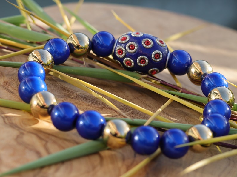 Handmade Indonesia Beads with 3D Miracle beads and a  mirrored top layer. ook into the bead, it looks like there is still a bead in it.