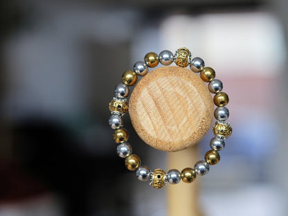 Gorgeous shiny Silver/ Gold Hematite 8 mm bracelet with Two—tone Metal Spacer Bead.