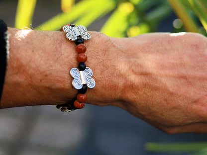 Glittering  Goldstone bracelet combined with wood and Butterfly spacers. A powerful beacon of growth and new beginnings