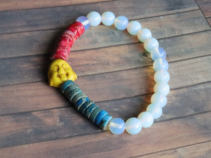 Interesting combination of rounded  Opalite and Heishi beads gives to the bracelet an original and unique design. 1x Howlite bead Buddha