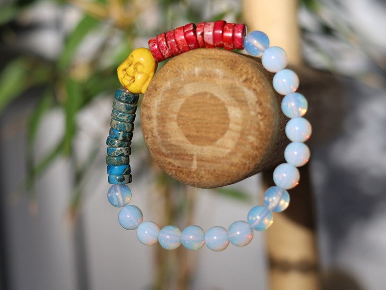 Interesting combination of rounded  Opalite and Heishi beads gives to the bracelet an original and unique design. 1x Howlite bead Buddha