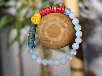Interesting combination of rounded  Opalite and Heishi beads gives to the bracelet an original and unique design. 1x Howlite bead Buddha
