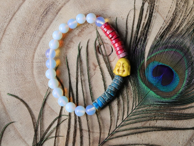 Interesting combination of rounded  Opalite and Heishi beads gives to the bracelet an original and unique design. 1x Howlite bead Buddha