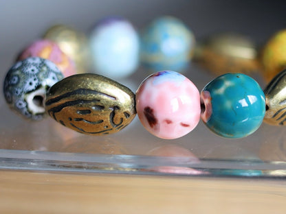 Fashionable Graphic Beaded bracelets with Metallook beads bronze almond shape. Shop online for handmade lifestyle jewelry and accessories.