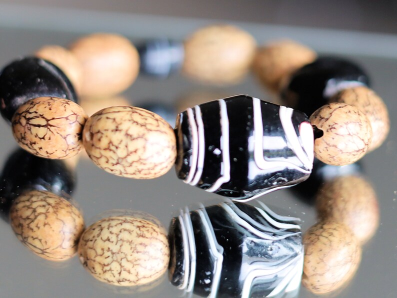 Handmade black/white striped clay beads combined with Undyed & Natural Bodhi Beads. which the Buddha sat when he attained Enlightenment
