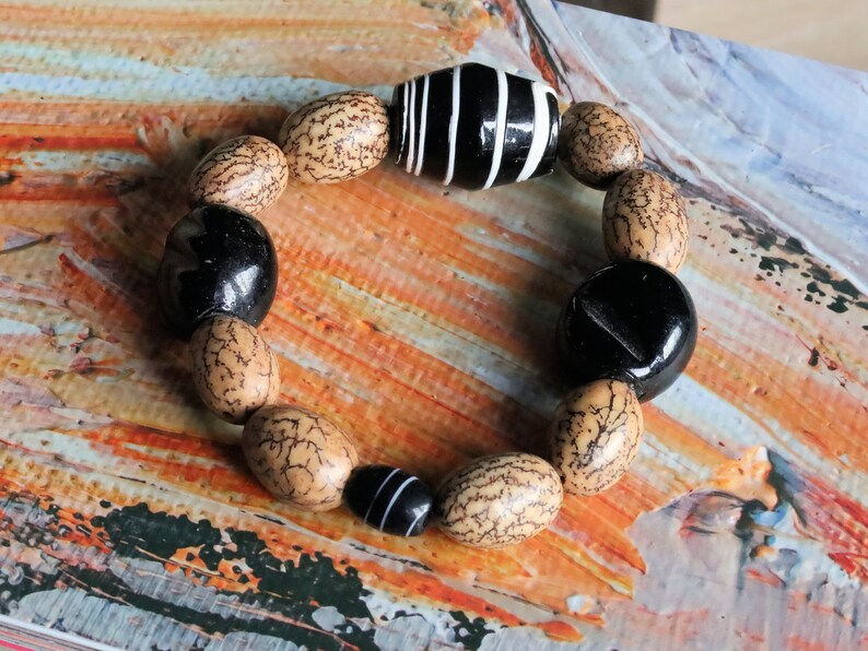 Handmade black/white striped clay beads combined with Undyed & Natural Bodhi Beads. which the Buddha sat when he attained Enlightenment