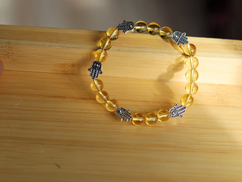Citrine is a master of one's creativity center combined with Tibetan Style Alloy Hamsa Hand. ENERGIZING CITRINE BRACELET