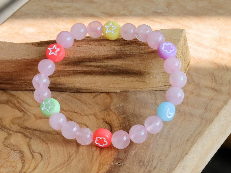 The Bāla Sagrahi Kids Collection. Children's Size 6 mm Rose Quartz Bracelet with kids acryl beads symbols. Gifts for kids!