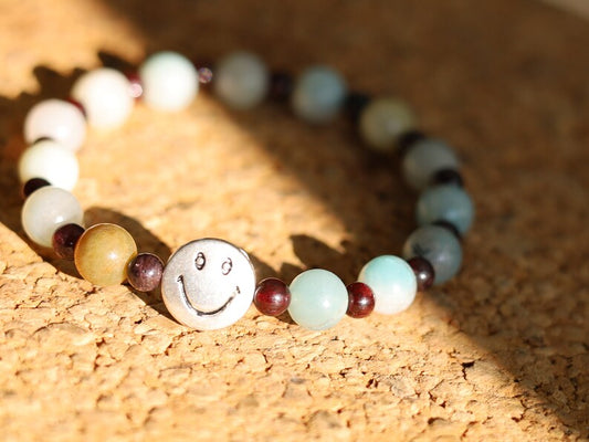 The Bāla Sagrahi Kids Collection. Children's Size Amazonite 6 mm Gemstone Bracelet with 4mm Red Garnet and Flat Round Happy Face Bead.