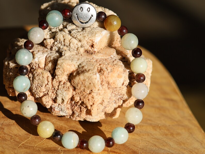 The Bāla Sagrahi Kids Collection. Children's Size Amazonite 6 mm Gemstone Bracelet with 4mm Red Garnet and Flat Round Happy Face Bead.