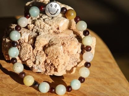 The Bāla Sagrahi Kids Collection. Children's Size Amazonite 6 mm Gemstone Bracelet with 4mm Red Garnet and Flat Round Happy Face Bead.