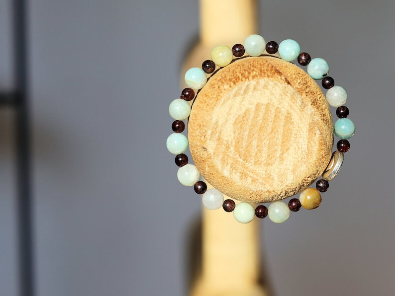 The Bāla Sagrahi Kids Collection. Children's Size Amazonite 6 mm Gemstone Bracelet with 4mm Red Garnet and Flat Round Happy Face Bead.