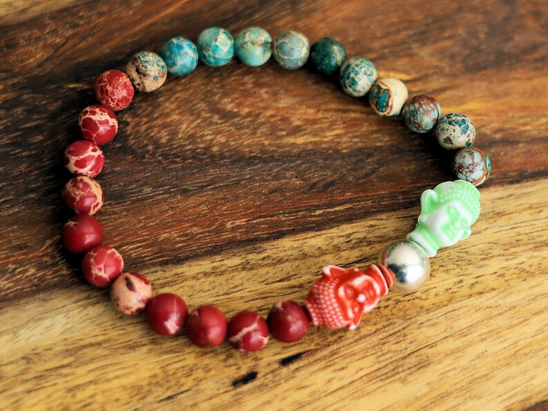 The Bāla Sagrahi Kids Collection. Children's Size Red and Turquoise Emperor Jasper 6 mm Gemstone Bracelet with 2x Buddha head.