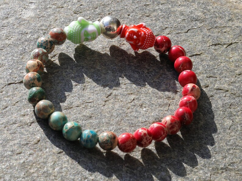 The Bāla Sagrahi Kids Collection. Children's Size Red and Turquoise Emperor Jasper 6 mm Gemstone Bracelet with 2x Buddha head.