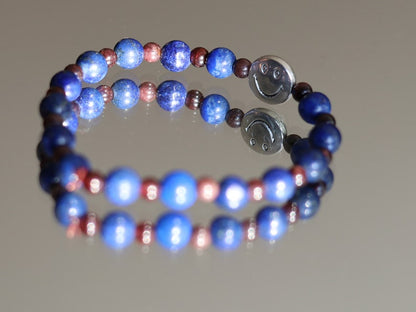 The Bāla Sagrahi Kids Collection. Children's Size Lapis Lazuli 6 mm Gemstone Bracelet with 4mm Red Garnet beads and Happy Face Bead.