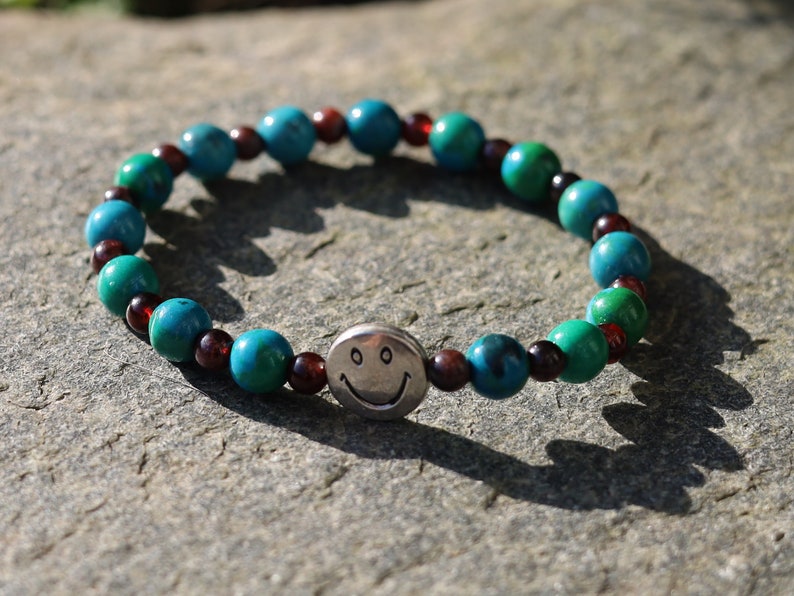 The Bāla Sagrahi Kids Collection. Children's Size Chrysocolla 6 mm Gemstone Bracelet with 4mm Red Garnet and Happy Face Bead.