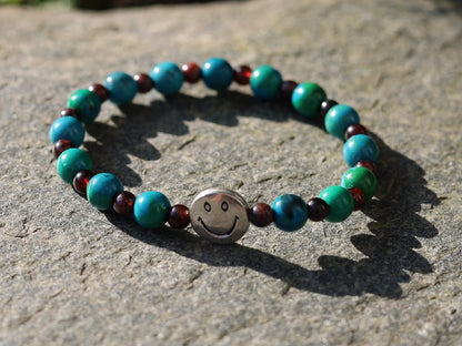 The Bāla Sagrahi Kids Collection. Children's Size Chrysocolla 6 mm Gemstone Bracelet with 4mm Red Garnet and Happy Face Bead.