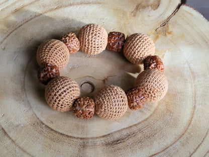 Particularly large Walnut Hand carved Bracelet with Crochet bead light brown. A larger, crocheted bead in light brown.