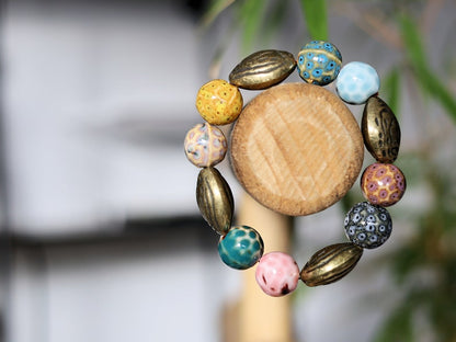 Fashionable Graphic Beaded bracelets with Metallook beads bronze almond shape. Shop online for handmade lifestyle jewelry and accessories.