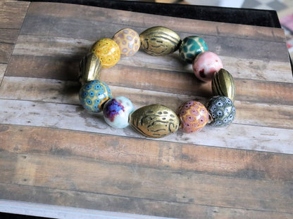 Fashionable Graphic Beaded bracelets with Metallook beads bronze almond shape. Shop online for handmade lifestyle jewelry and accessories.