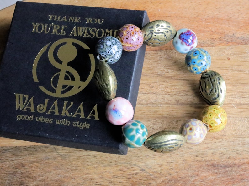 Fashionable Graphic Beaded bracelets with Metallook beads bronze almond shape. Shop online for handmade lifestyle jewelry and accessories.