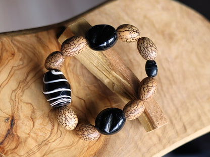 Handmade black/white striped clay beads combined with Undyed & Natural Bodhi Beads. which the Buddha sat when he attained Enlightenment