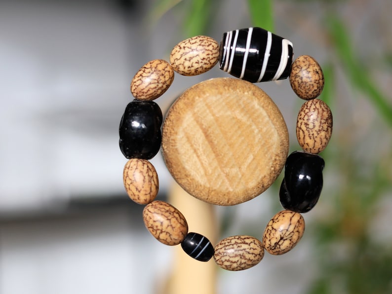 Handmade black/white striped clay beads combined with Undyed & Natural Bodhi Beads. which the Buddha sat when he attained Enlightenment