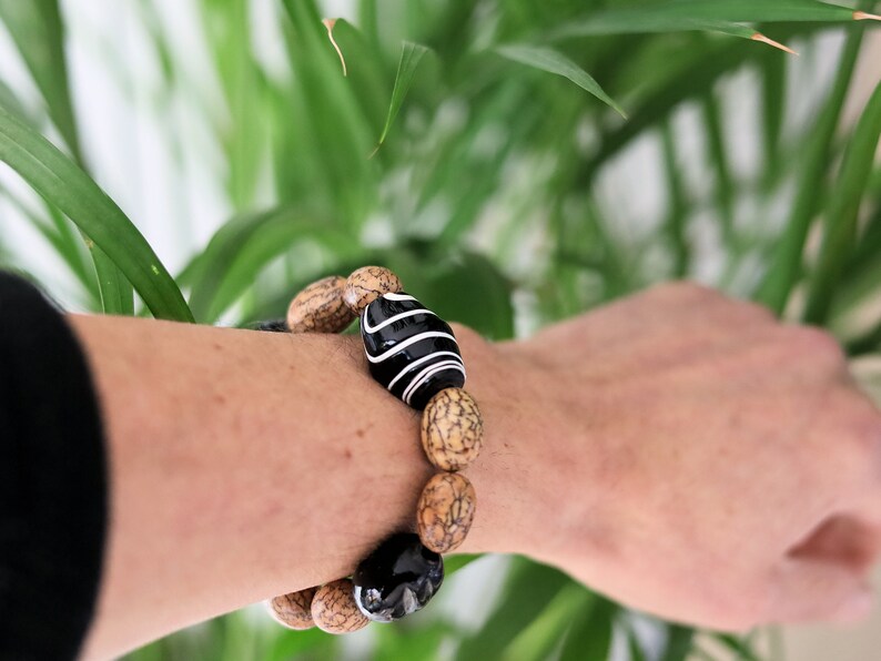 Handmade black/white striped clay beads combined with Undyed & Natural Bodhi Beads. which the Buddha sat when he attained Enlightenment