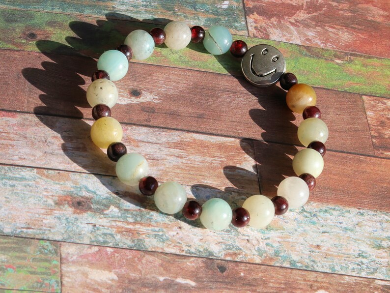 The Bāla Sagrahi Kids Collection. Children's Size Amazonite 6 mm Gemstone Bracelet with 4mm Red Garnet and Flat Round Happy Face Bead.