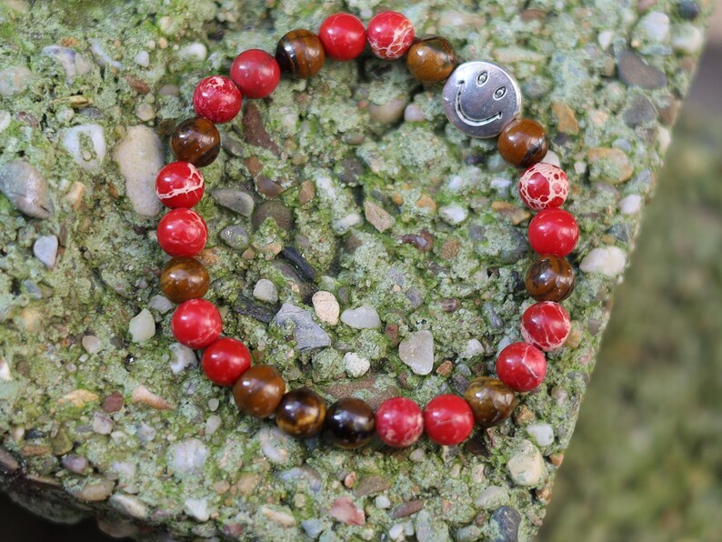 The Bāla Sagrahi Kids Collection. Children's Size Red Emperor Jasper 6 mm Gemstone Bracelet with Tiger eye and Happy Face Bead.