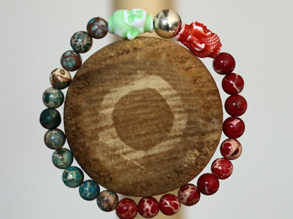 The Bāla Sagrahi Kids Collection. Children's Size Red and Turquoise Emperor Jasper 6 mm Gemstone Bracelet with 2x Buddha head.