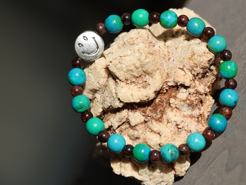 The Bāla Sagrahi Kids Collection. Children's Size Chrysocolla 6 mm Gemstone Bracelet with 4mm Red Garnet and Happy Face Bead.