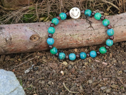 The Bāla Sagrahi Kids Collection. Children's Size Chrysocolla 6 mm Gemstone Bracelet with 4mm Red Garnet and Happy Face Bead.