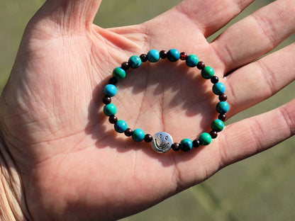 The Bāla Sagrahi Kids Collection. Children's Size Chrysocolla 6 mm Gemstone Bracelet with 4mm Red Garnet and Happy Face Bead.
