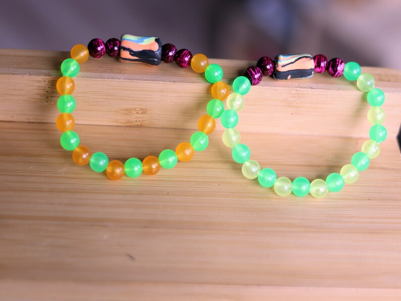 Glow in the dark - 2x bracelets mixed colored beads combined with clay Blacklight beads and ink purple color beads.