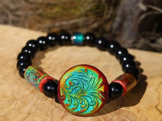 Color-changing Mirāja collection. Black Agates Carnelian bracelet with Mirage Mood Fountain Fern Coin Bead. Mirage Mood Glow Nouveau Bead.