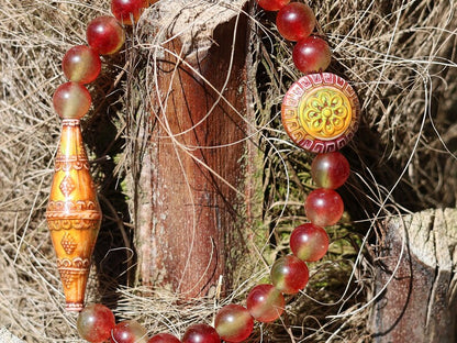 Color-changing Mirāja collection.  Watermelon Jade bracelet with Mirage Mood Bali Sunset Elongated Bicone Bead. Mirage Mood Sun Blossom Bead