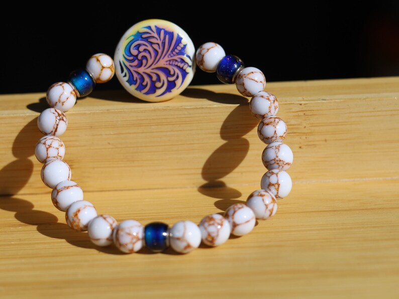 Color-changing Mirāja collection. White Turquoise Gold Color Wire Pine bracelet. Mirage Mood Fountain Fern Coin and Changing barrel beads.
