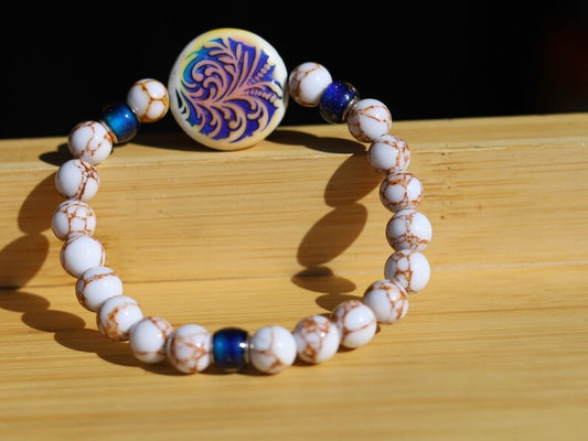 Color-changing Mirāja collection. White Turquoise Gold Color Wire Pine bracelet. Mirage Mood Fountain Fern Coin and Changing barrel beads.
