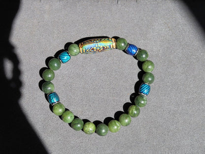 Color-changing Mood Mirāja collection. Green Chalcedony Stone bracelet with Mirage Mood Daisy Ray Bead and  Color Changing barrel beads.